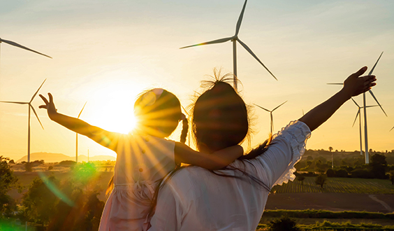 woman and child looking at wind farm