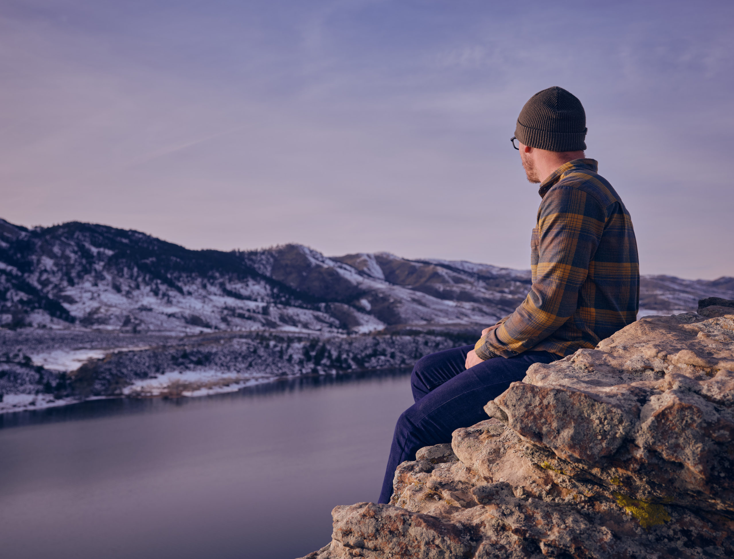 man sitting near horsetooth reservoir