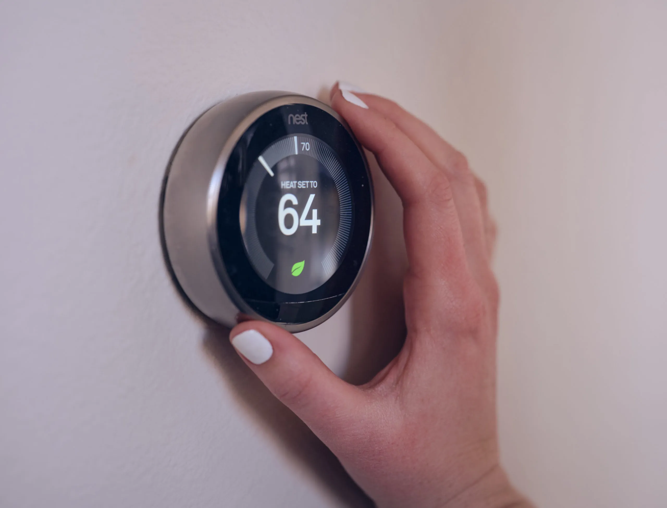 hand adjusting smart thermostat