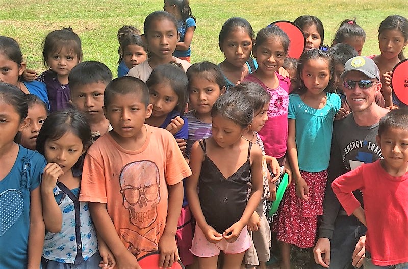 Lineman poses with the local children from the Guatemalan village.