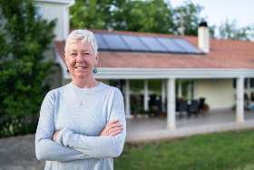 woman standing in front of home