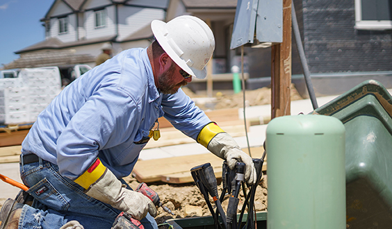 Lineman hooking up lines at a new house