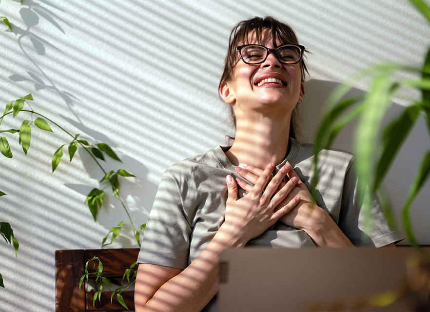 smiling women in front of computer