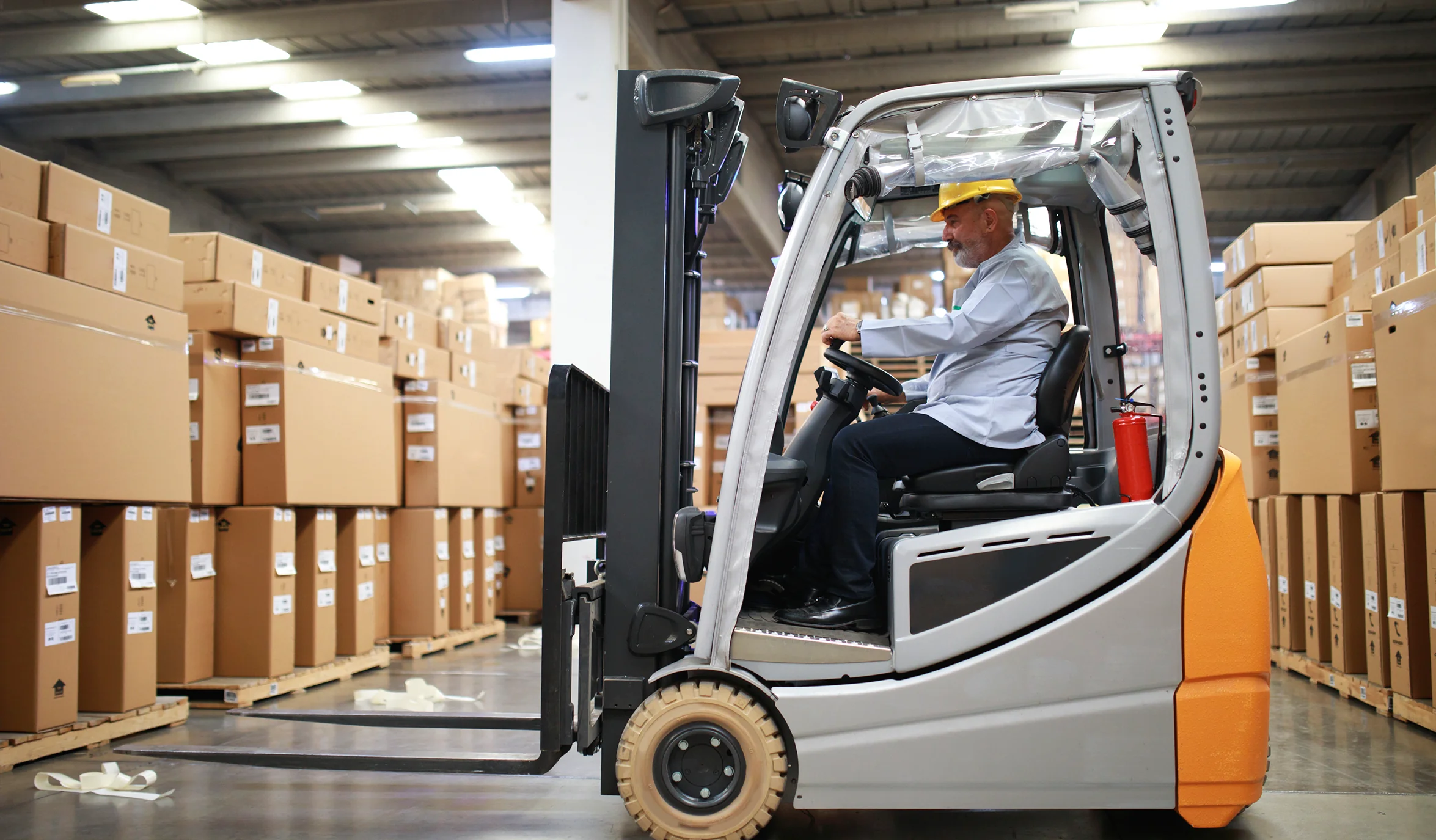 Man driving an electric forklift in a warehouse