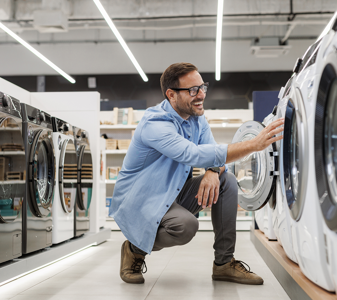 Man looking at washing machine