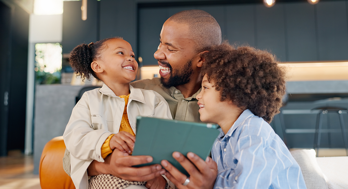 Smiling family looking at a tablet