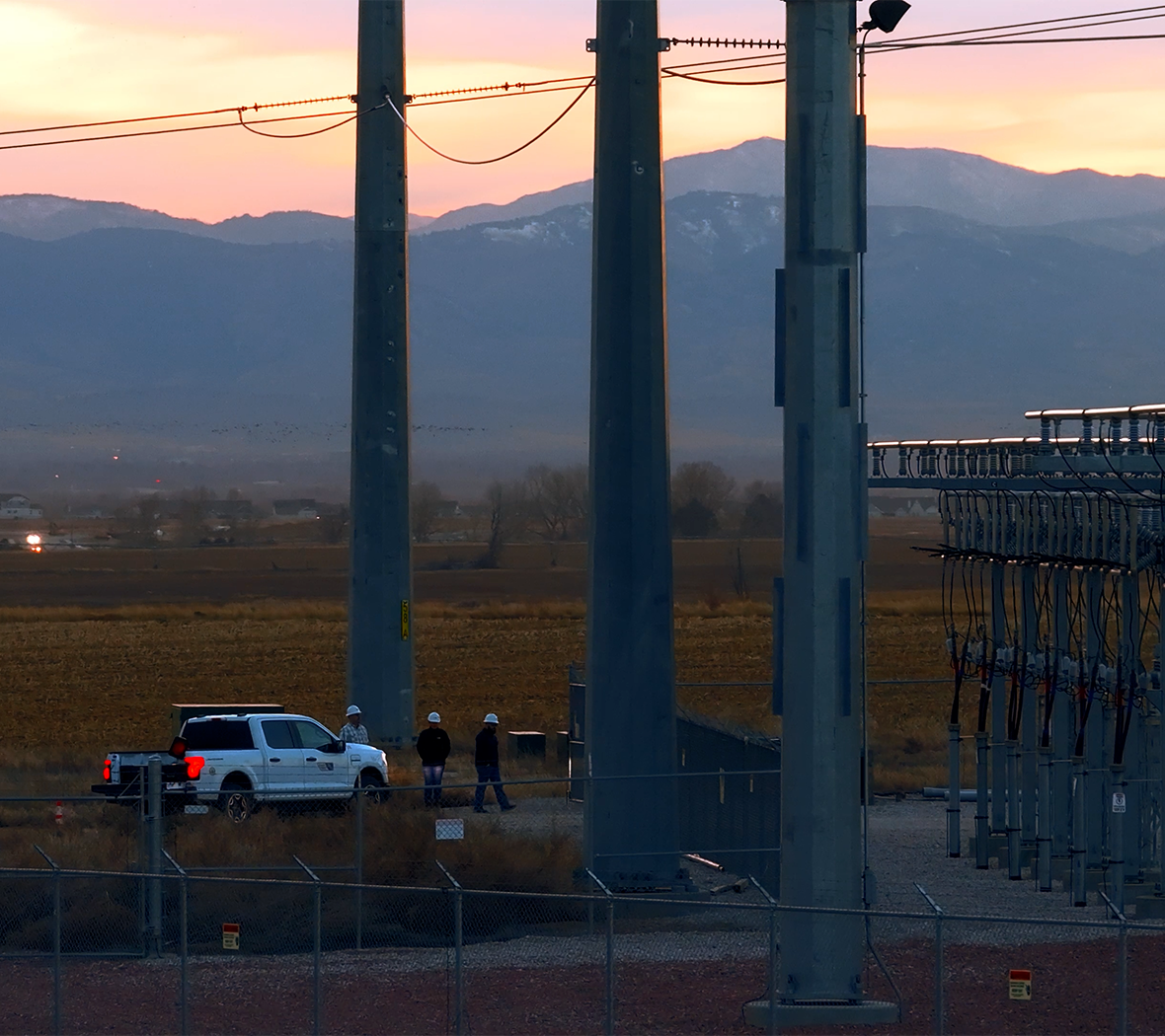 PVREA Employees Walk Together Near Equipment