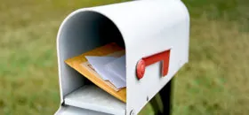 white mailbox open with mail inside