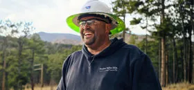 Electrical worker smiling in forest