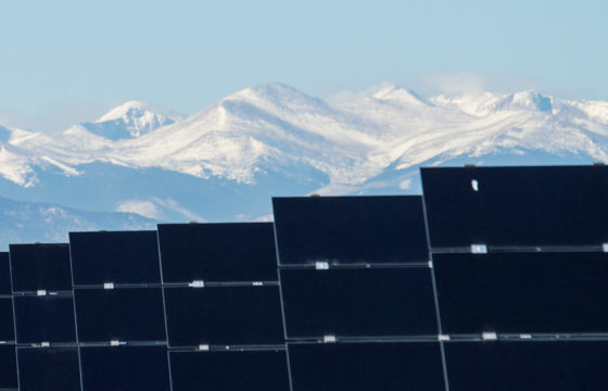 View of Solar Panels With Mountains In The Background