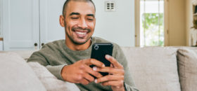 Man on couch using phone