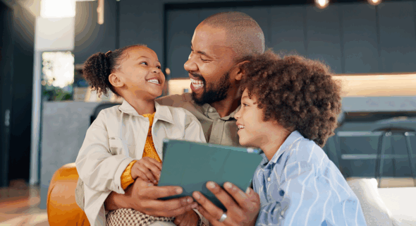 Smiling family looking at a tablet