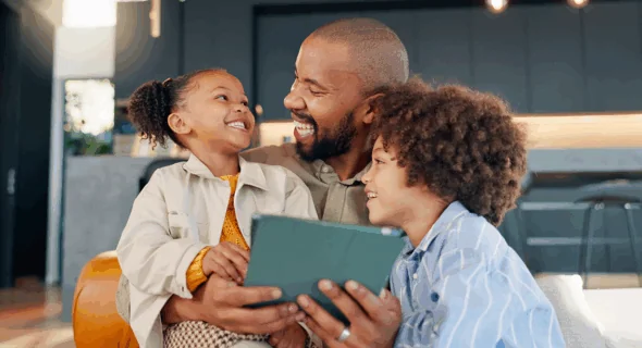 Smiling family looking at a tablet