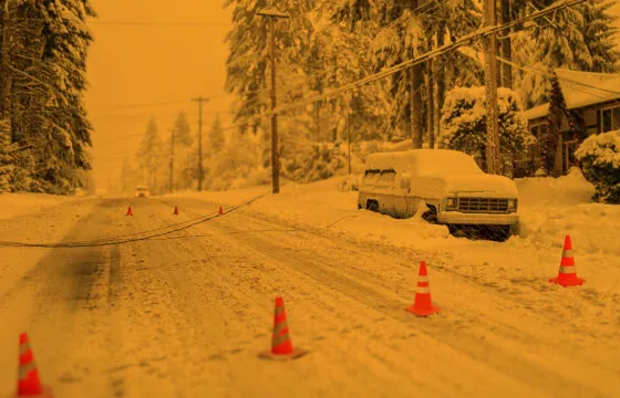 Stay Safe Around Downed Utility Lines header image - car buried in snow on a road, downed powerline nearby