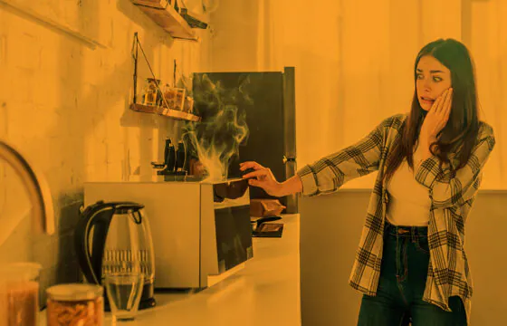 Safety Corner: Super Bowl Safety Tips Header - person opening up burning oven