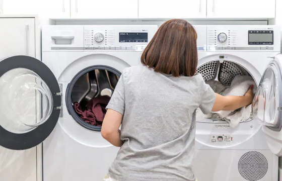 Understanding Demand: Why it matters header - person moving laundry from washer to dryer
