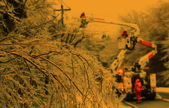 Lineworkers working to repair power lines impacted by heavy, wet snow.