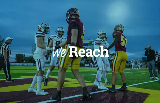 Windsor and Severance football players shake hands with 'We Reach' text overlay.